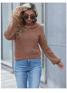 Detail of caramel knit sweater featuring a wide collar and V-neck button closure