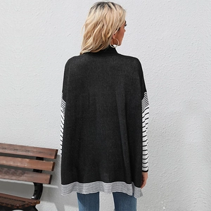 Women's loose black turtleneck knit sweater with striped hem and cuffs back view