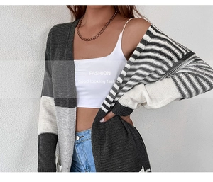 Detail showing grey and white colorblock stripe texture on long knit cardigan