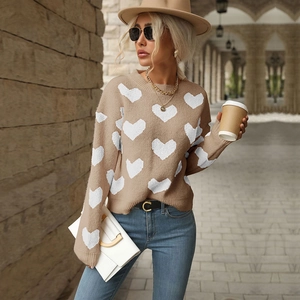 Detail of khaki knit sweater for women featuring white heart patterns and round neck
