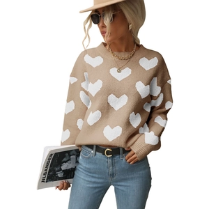 Detail showing khaki knit sweater with white heart pattern and round neckline