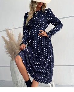 Detailed close-up of dark blue polka dot midi dress with elastic high waist and long sleeves