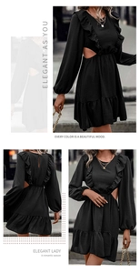 Detail view of black cut-out dress with ruffle trim and long lantern sleeves