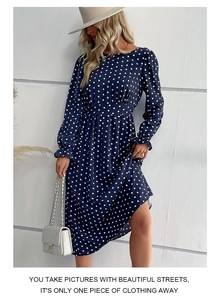 Close-up of the elastic waist and white polka dot pattern on the navy blue chiffon dress