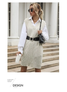 Detail of beige cable-knit sweater vest with V-neck and pearl-buckle belt in retro style