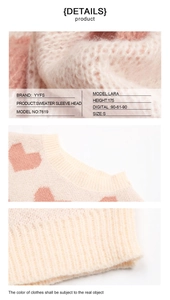 Detailed texture of pink heart knit sweater featuring ribbed neckline and soft fabric