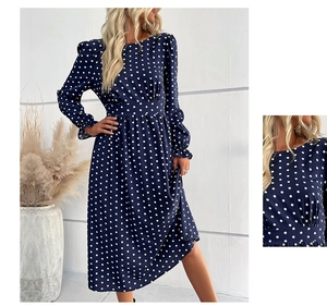 Detail of ruffled cuffs and white polka dot pattern on a navy blue long sleeve dress