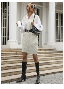 Close-up of cream cable knit vest dress with V-neckline and textured patterns