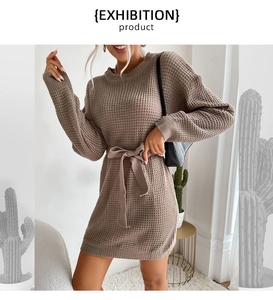 Close-up of khaki waffle knit sweater dress with round neck and tie-waist detail