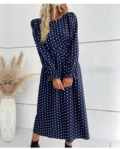 Detail shot of the ruffled cuffs and white polka dot pattern on the long-sleeved blue dress
