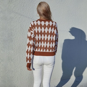 Women's crewneck sweater featuring brown and white argyle pattern with ribbed cuffs