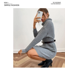 Detail of grey high-neck knit dress with ribbed texture and chic black gold-buckle belt