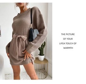 Detail of brown waffle knit fabric texture and matching tie-waist belt on dress
