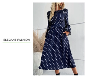 Detail of elegant navy blue long sleeve dress with white polka dots and waisted design