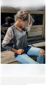 Detail of grey knit sweater with V-neck and delicate white lace patchwork sleeves