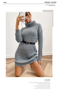 Close-up of grey high-neck ribbed knit dress with long sleeves and a black gold-buckle belt
