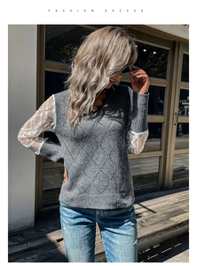 Detail view of grey V-neck knit sweater featuring elegant white lace patchwork sleeves