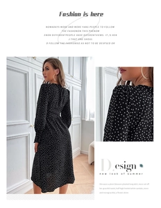 Detail of elegant black polka dot dress featuring ruched waist and long cuffed sleeves