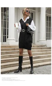 Detailed view of a black cable knit vest paired with a pearl buckle belt and leather boots
