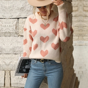 Chic cream knit sweater with pink heart jacquard pattern and classic crewneck