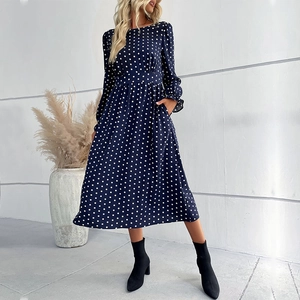 Navy blue polka dot long sleeve midi dress with waist cinching and crew neck design