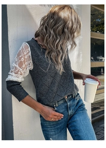 Detail of grey knit sweater showing intricate diamond texture and floral lace sleeves