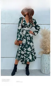 Detailed view of dark green floral dress with intricate white lace waist and V-neckline