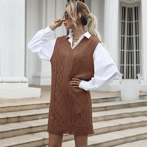 Women's brown cable-knit V-neck vest dress layered with a white shirt in street style
