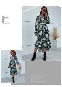 Detail of dark green floral V-neck dress with white lace waist and ruffle high-low hem