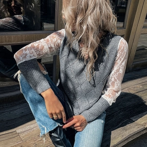 Women's grey knit sweater featuring white lace patchwork sleeves in a boho casual style