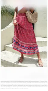 Detail of bohemian red floral maxi skirt featuring an elastic high waist and tiered design