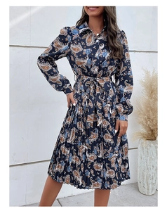 Detail of navy blue paisley pleated dress featuring shirt collar and button-down front
