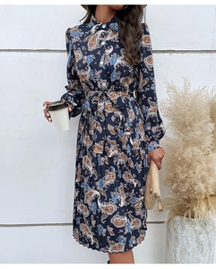 Detailed view of long sleeve paisley print dress with lapel collar and pleated skirt
