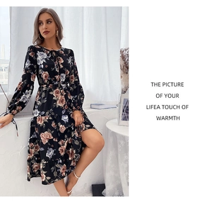 Close-up of floral print dress featuring lace-up crew neck and delicate tiered skirt