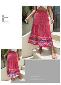 Detail of bohemian red floral maxi skirt with elastic waist and paisley hem pattern