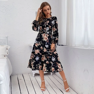 Black long-sleeve floral dress with tiered skirt and tassel drawstring neckline