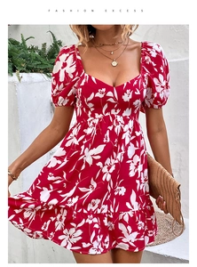 Detail view of red floral dress featuring a sweetheart neckline and ruffled hemline