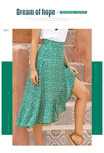Detail view of green floral wrap midi skirt featuring ruffled hem and side slit detail