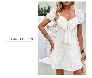 Détail de la robe élégante en dentelle anglaise blanche avec nœud et manches bouffantes