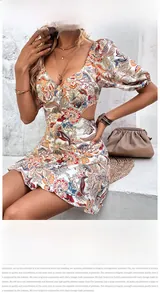 Close-up of paisley floral print dress with side waist cut-out and puff sleeves