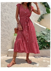 Detail of red floral maxi dress showing white buttons and adjustable waist tie