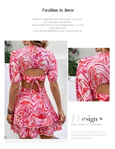 Detail of summer two-piece set with backless tie-up top and layered skirt in swirl print
