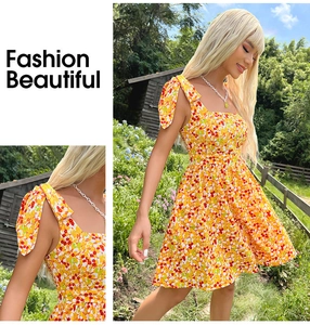 Detailed view of yellow floral summer dress with adjustable shoulder bow ties and square neck