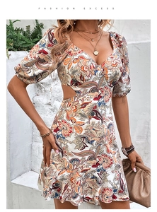 Detail of waist cut-out and paisley print on a bohemian summer v-neck dress