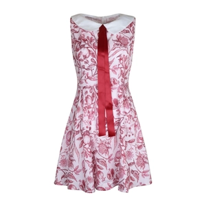 Close-up of white Peter Pan collar with a red ribbon tie on floral print dress