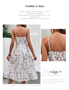 Detail of colorful butterfly print and ruffled tiered hem on a white summer midi dress