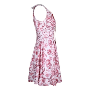 Detailed close-up of white A-line dress featuring red pomegranate and floral print