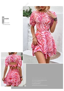 Detail of bohemian pink wave print dress featuring side cut-outs and a backless tie design