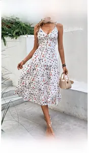 Detail of V-neck white summer dress with colorful butterfly print and tiered skirt