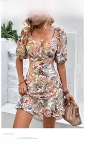 Detail of bohemian paisley print dress with waist cut-outs and puff sleeves